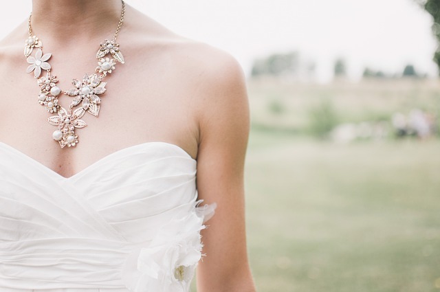 A bride in a simple wedding dress from NZ wearing a necklace